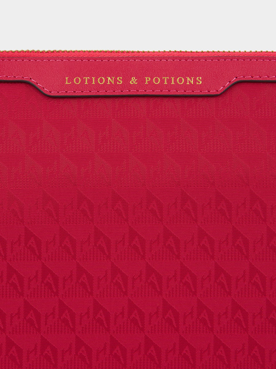 Anya Hindmarch | Lotions and Potions Pouch in AH Logo Magenta